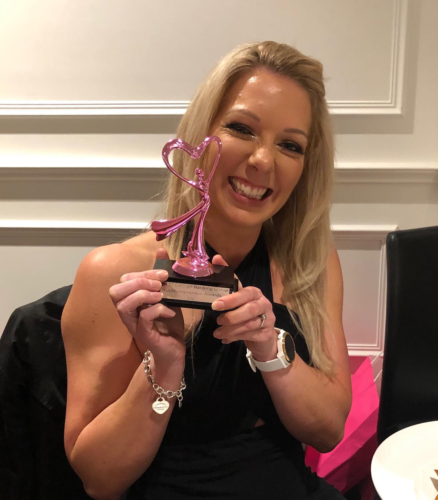 Kelly Dennis showing her award